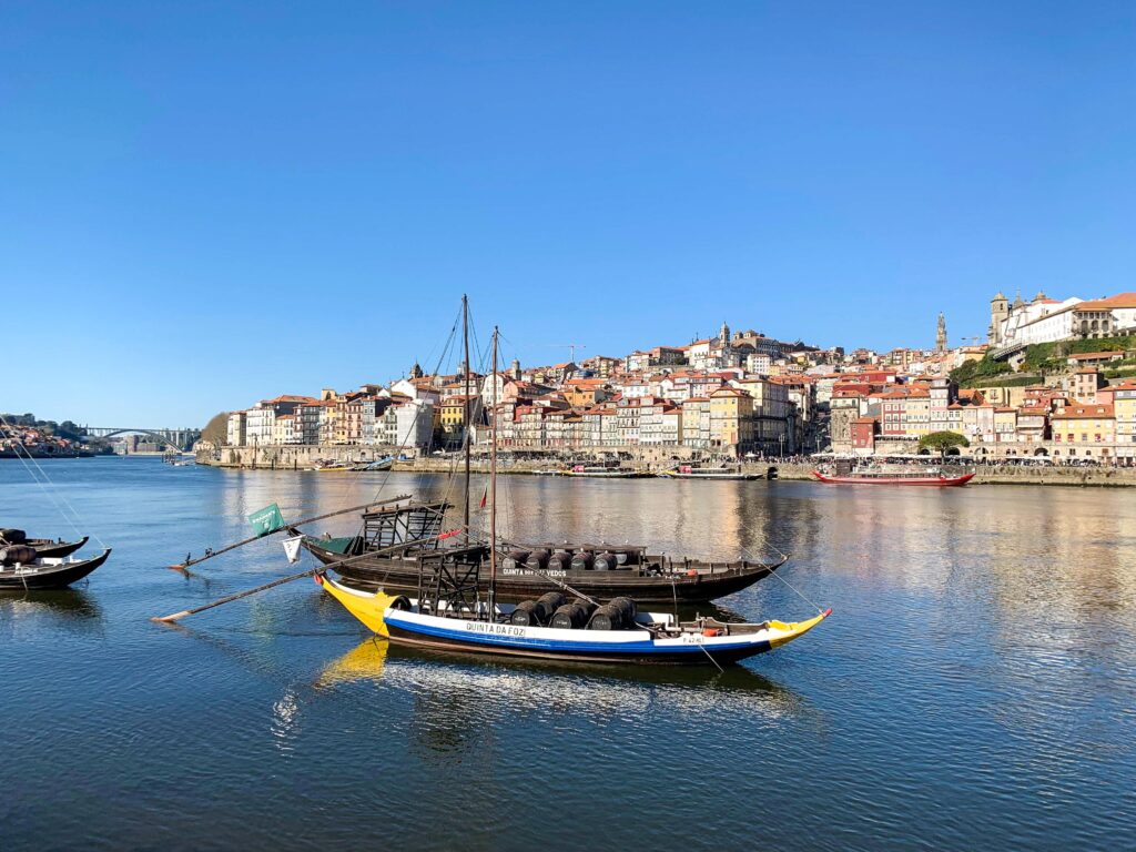 river with wooden boats and city on riverside in one of the most instagrammable places in porto