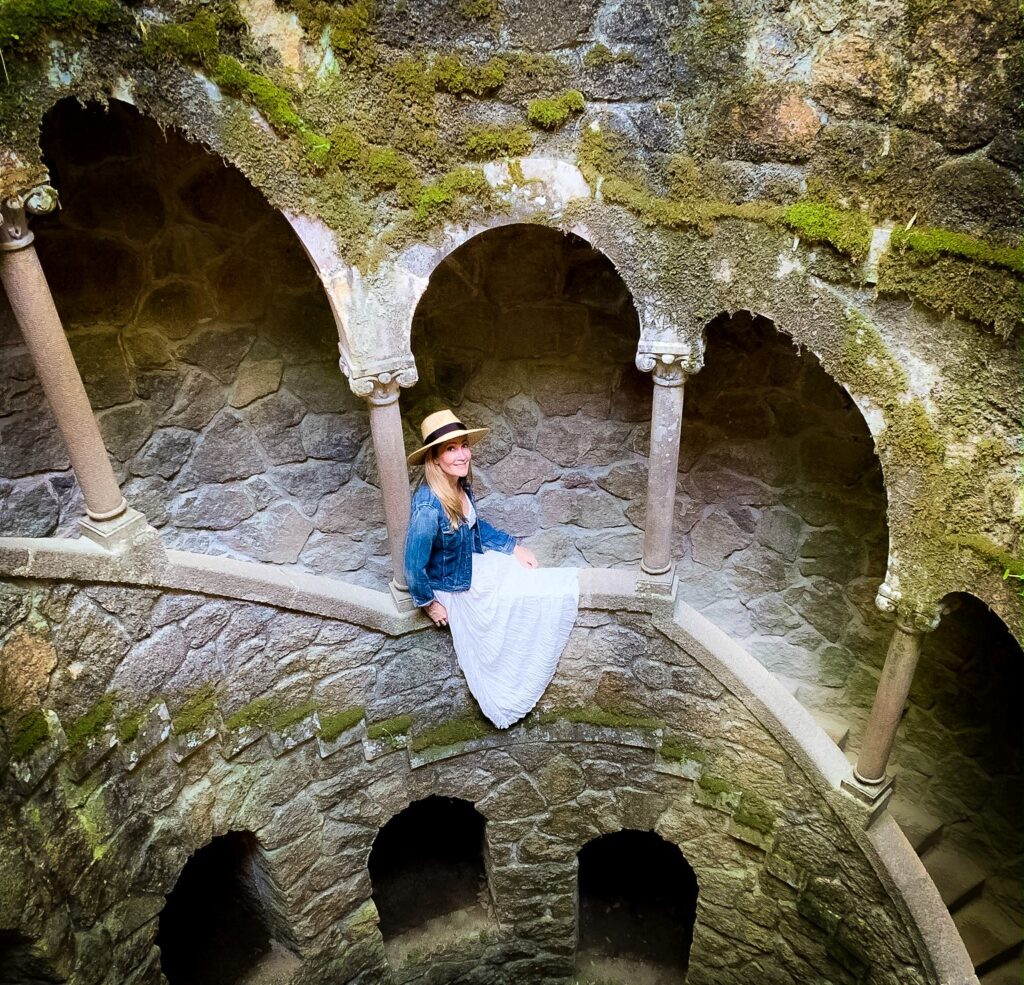 tunnel with moss and girl on edge in one of the most instagrammable places in Sintra