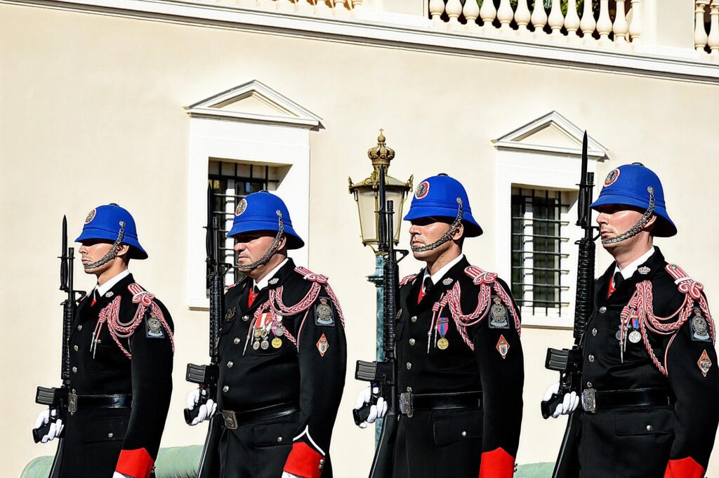 4 guards with blue hats, black jackets seen on a day trip to Monaco