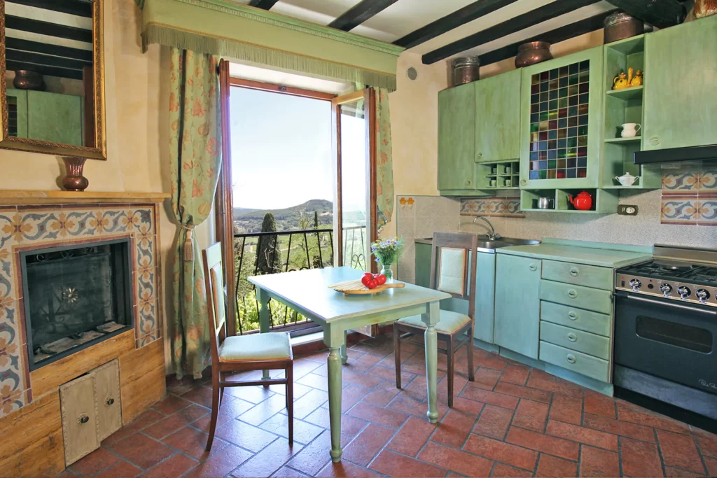 green kitchen with table and chairs with view to tuscan countryside in places to stay in Montepulciano