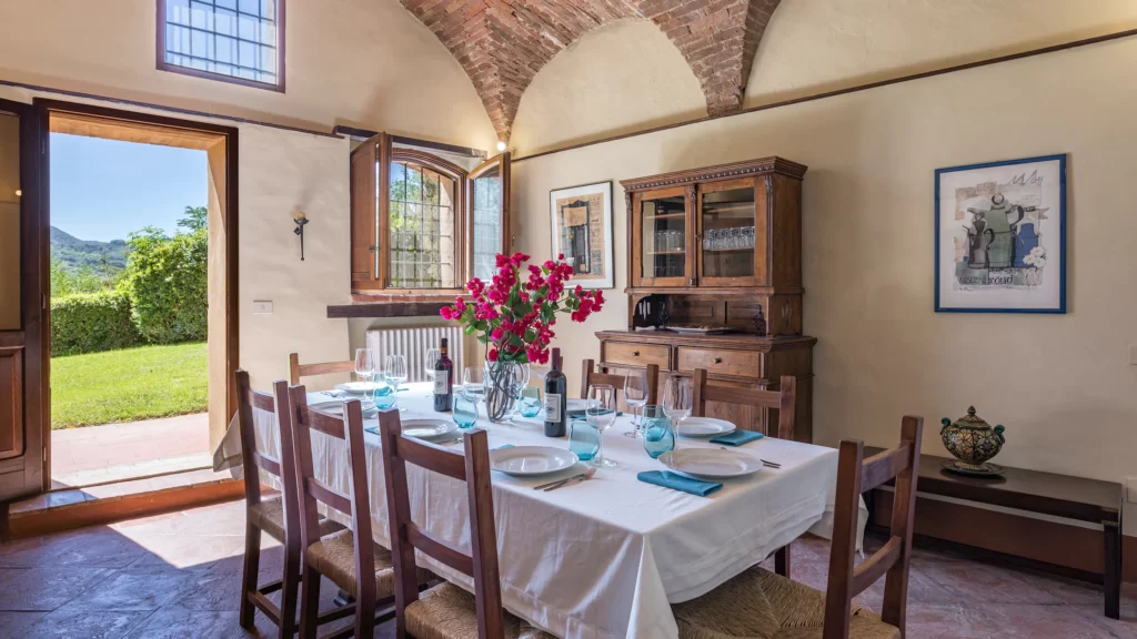 dining space with door open to view of countryside in one of the best places to stay in montepulciano