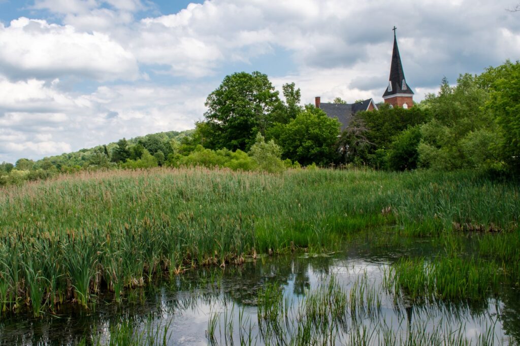 pond with church steeple in Haut-Saint-François in the Eastern Townships, Quebec.