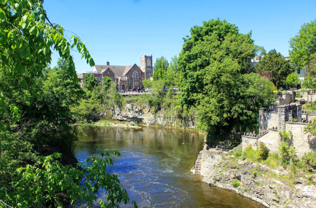 river with trees and church in fergus 