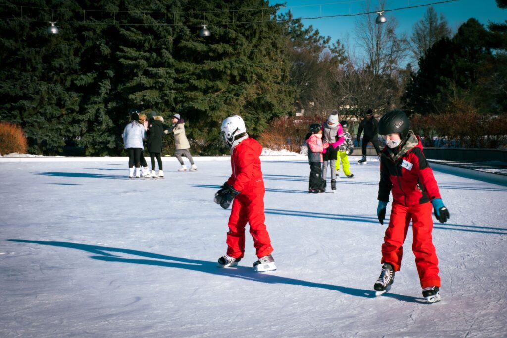 skating in ottawa with 2 kids in red snowsuits