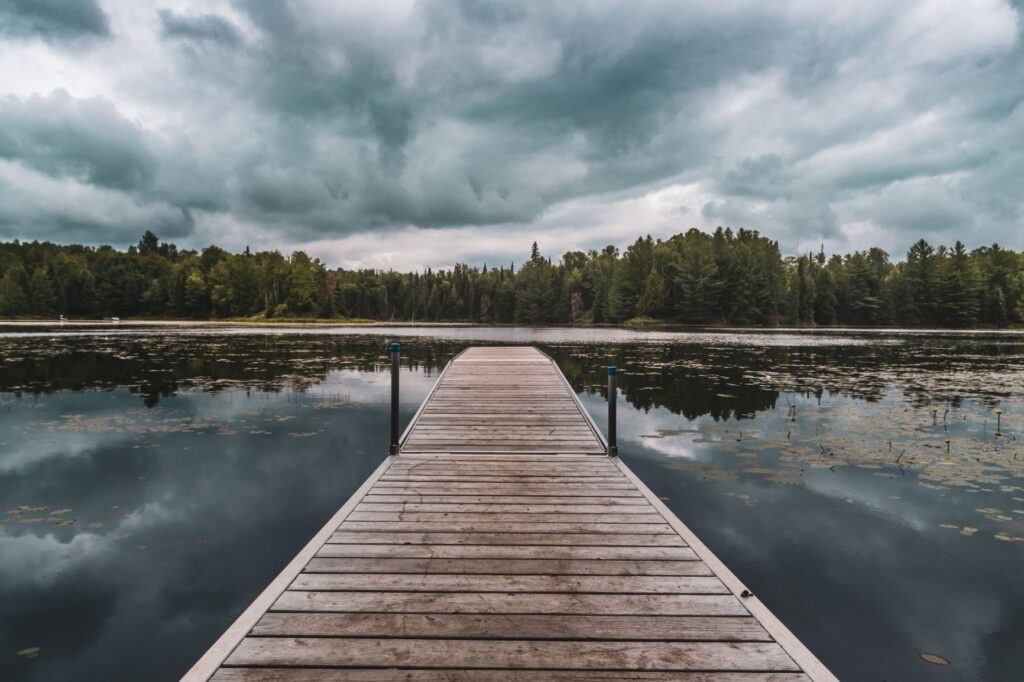 dock on water with stormy clouds at hinterhouse