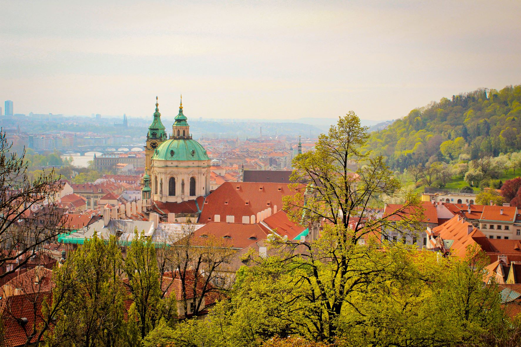 view of prague with red rooftops and dome roof