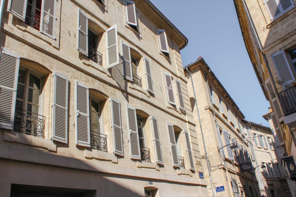 buidling in avignon with pale blue shutters in old town