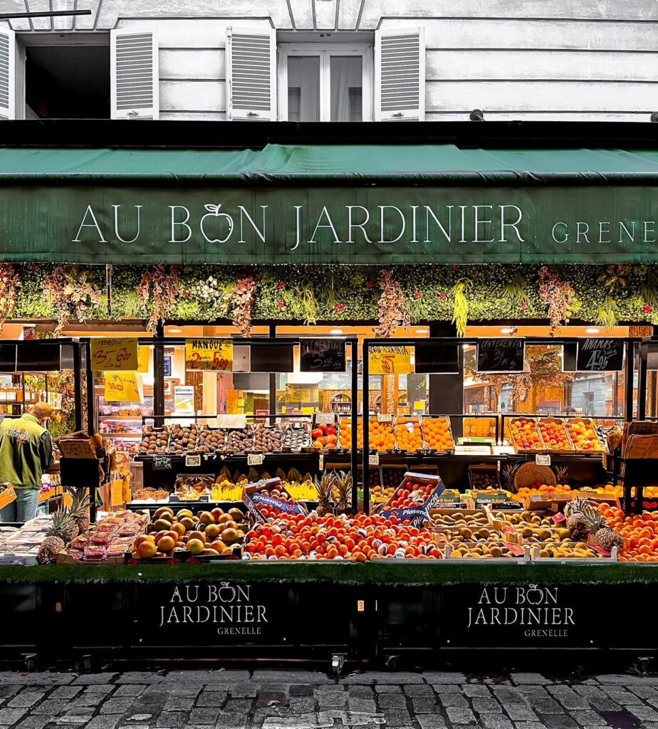 cobblestone street in paris with market stand with produce 