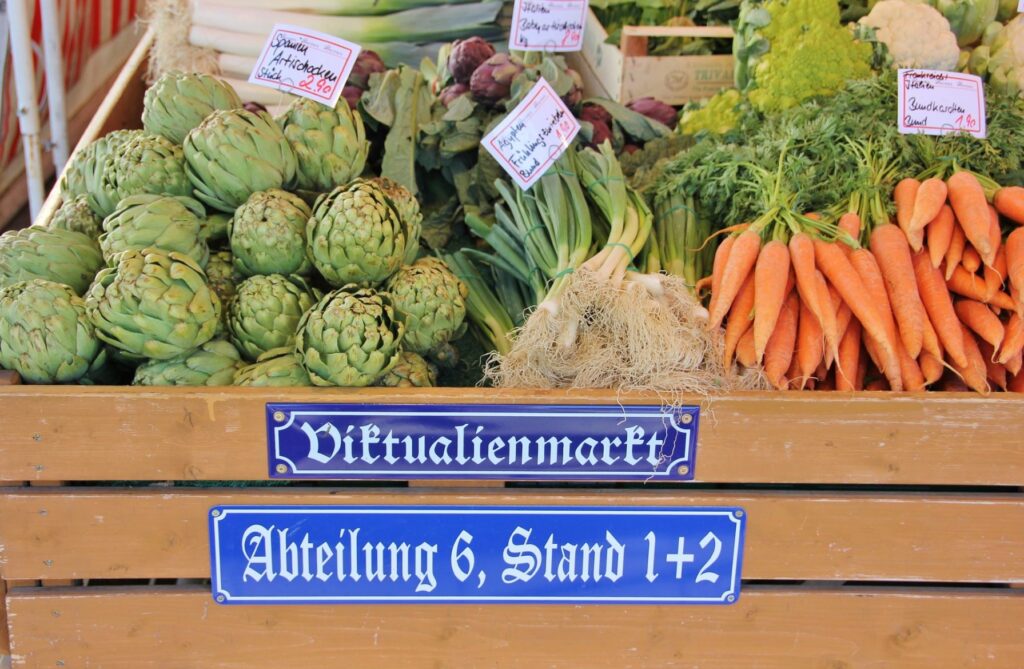 market stand with carrots, artichokes