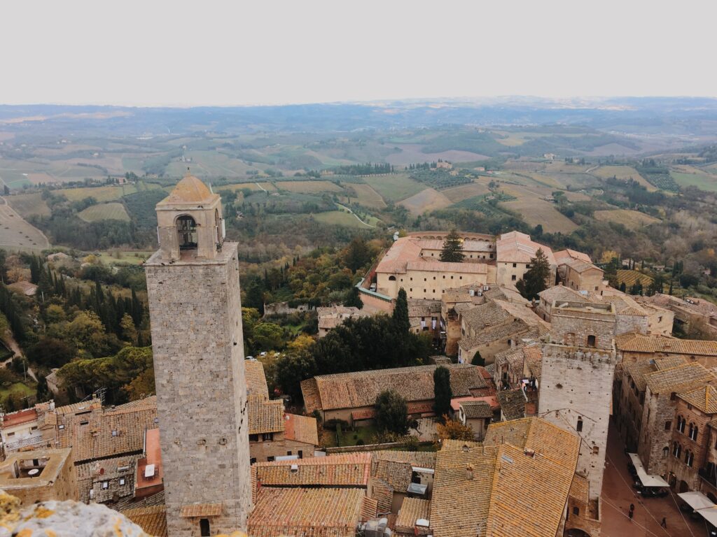 tower over walled city as one of the best tuscan towns in italy