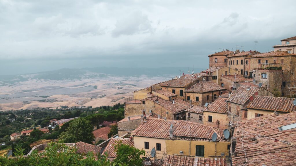 view from hilltop tuscan town of volterra with buildings and trees
