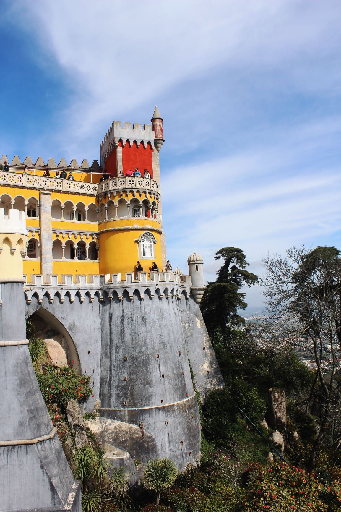 Gray stone with yellow and red tower atPena Palace Sintra