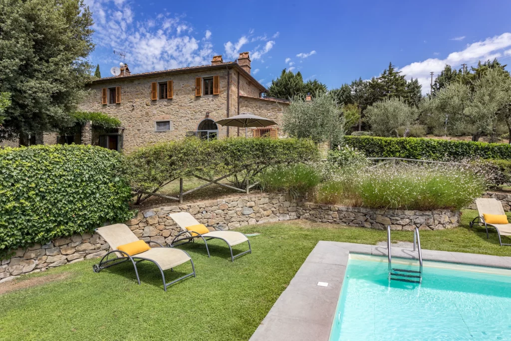 pool, loung chairs, garden with stone villa for rent in cortona for vacation