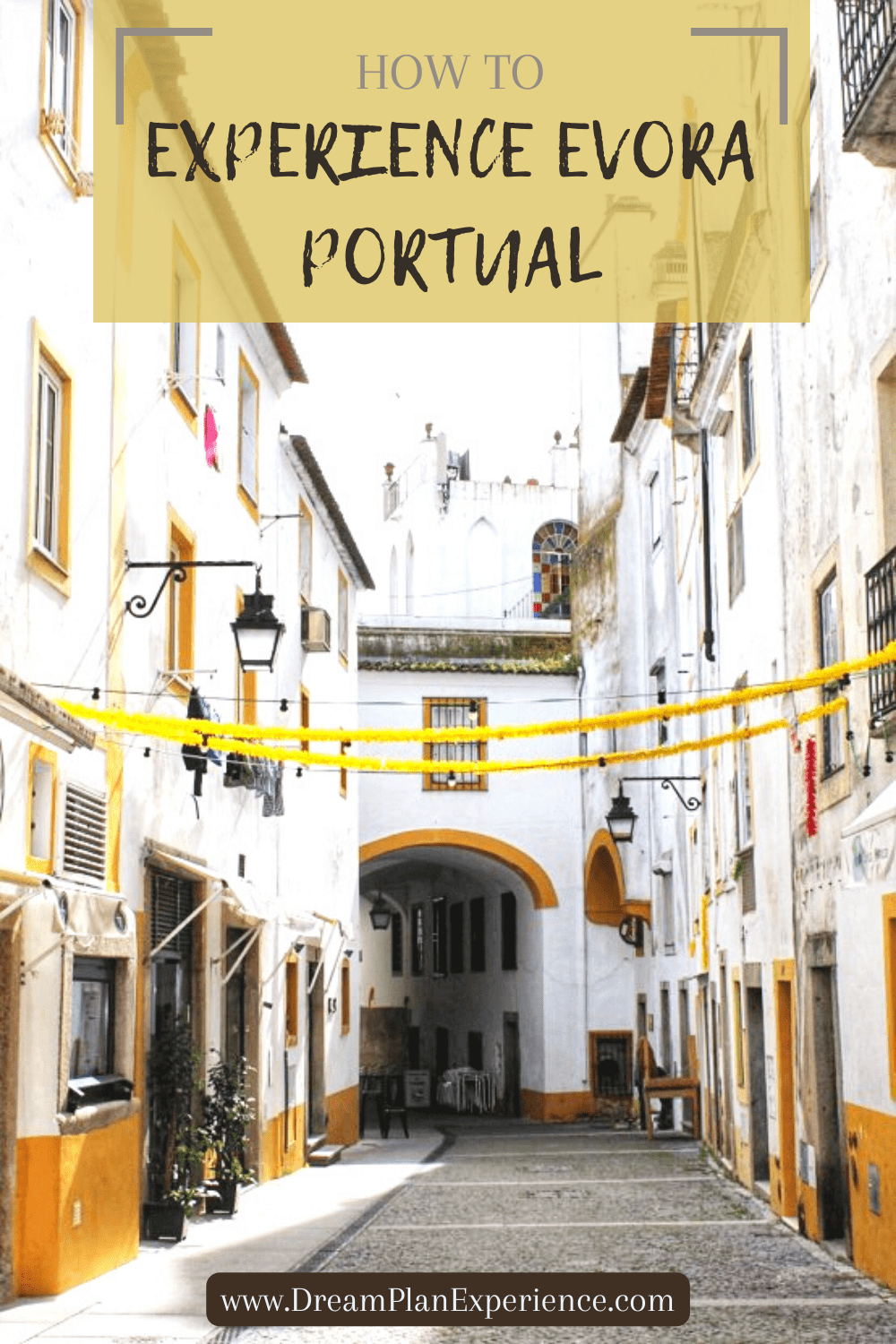 white building with yellow trim in evora portugal