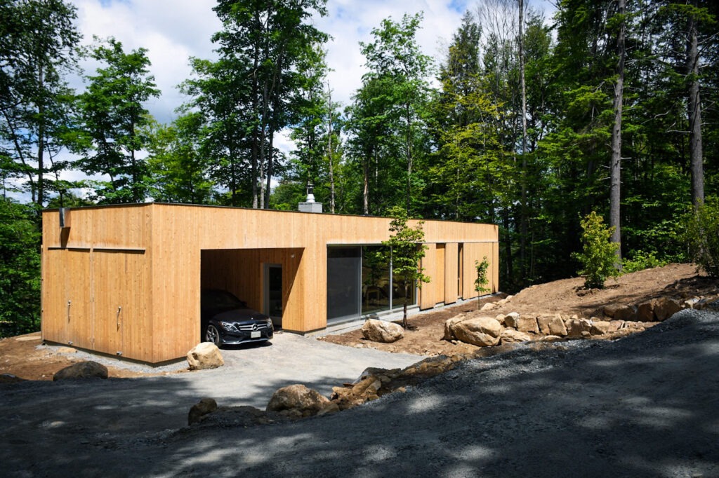 wooden cabin surrounded by trees called hinterhouse