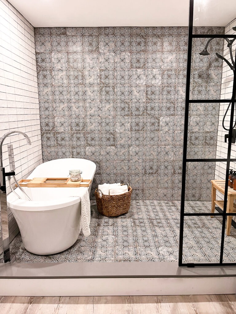 tub with black and white tile in shower in airbnb when staying in cute ontario towns