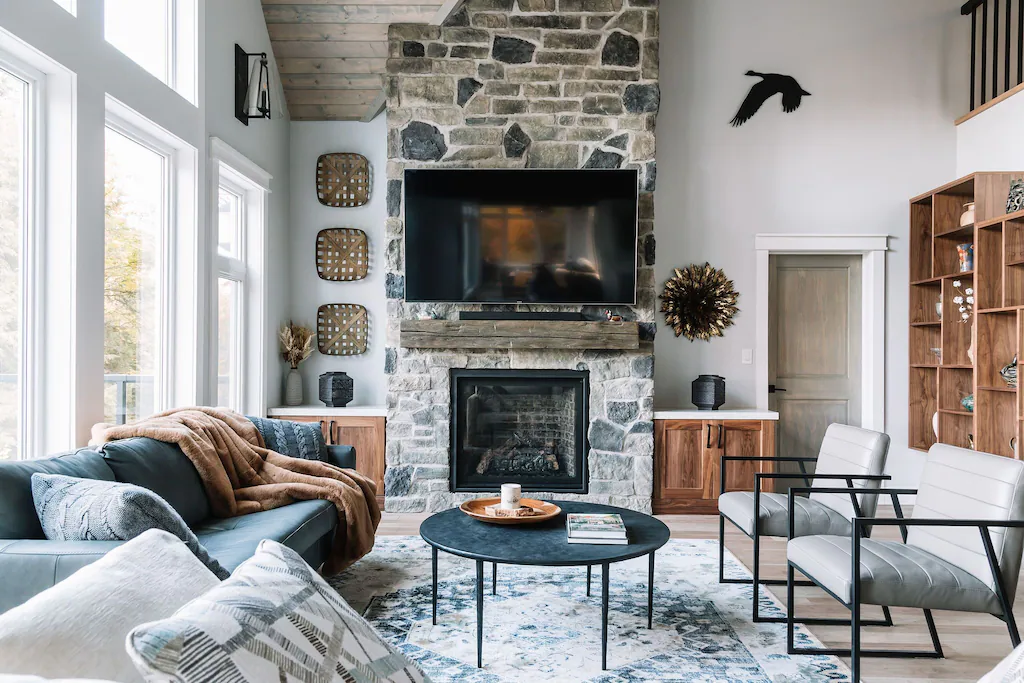 fireplace, tv, sofa and window in airbnb haliburton