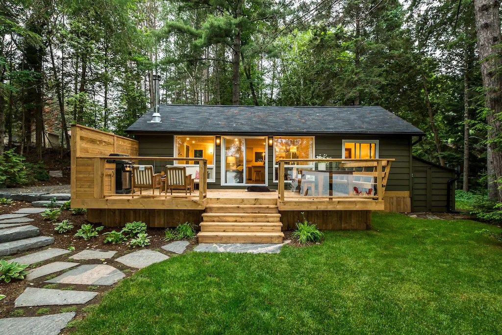 cottage with deck surrounded by trees in haliburton