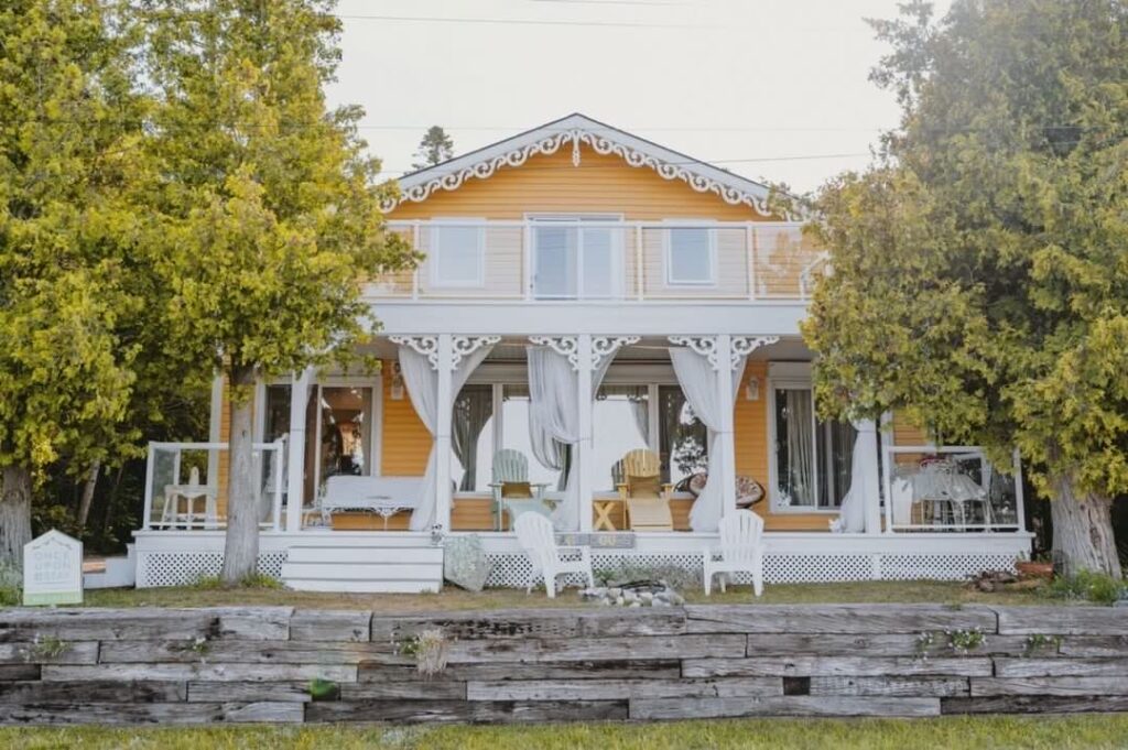 yellow cottage with porch in airbnb sauble beach