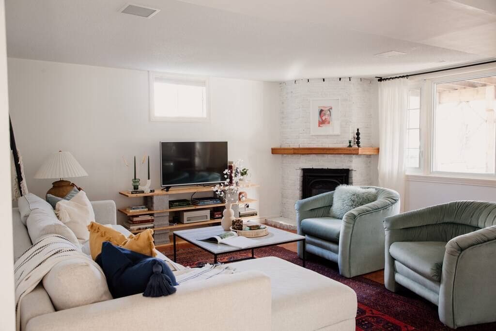 living space, fireplace, chairs, sofa in airbnb prince edward county