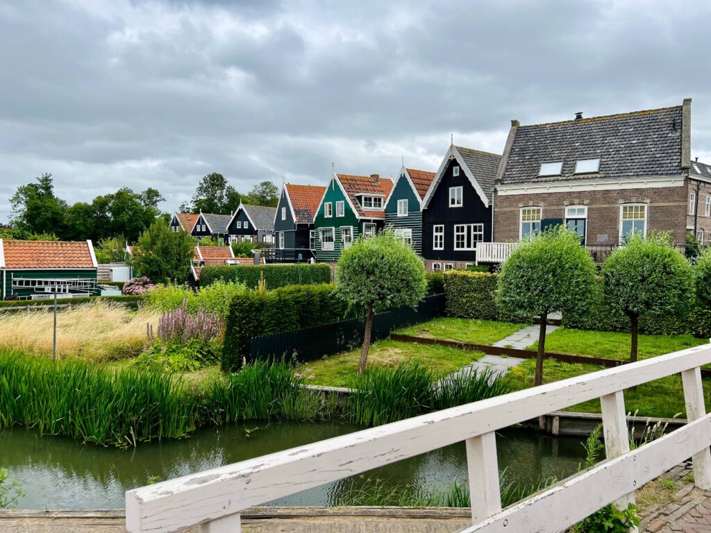 bridge, canal with houses in amsterdam countryside in netherlands