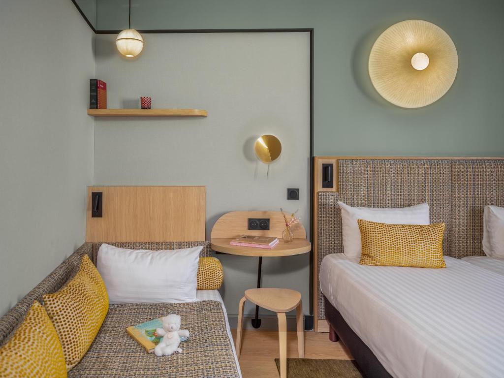Classic luxury boutique Paris hotel room with warm wood furnishings, white linens, and understated decor creating a calm and comfortable retreat. 