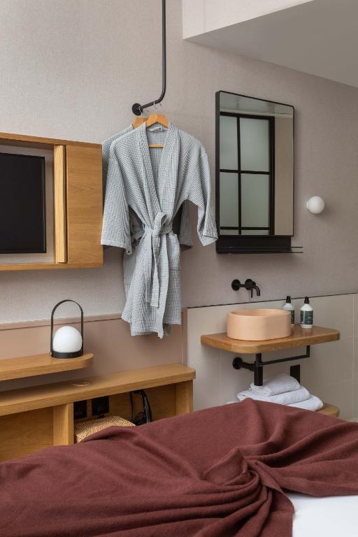 bed, with sink, mirror and tv in affordable luxury hotels in london