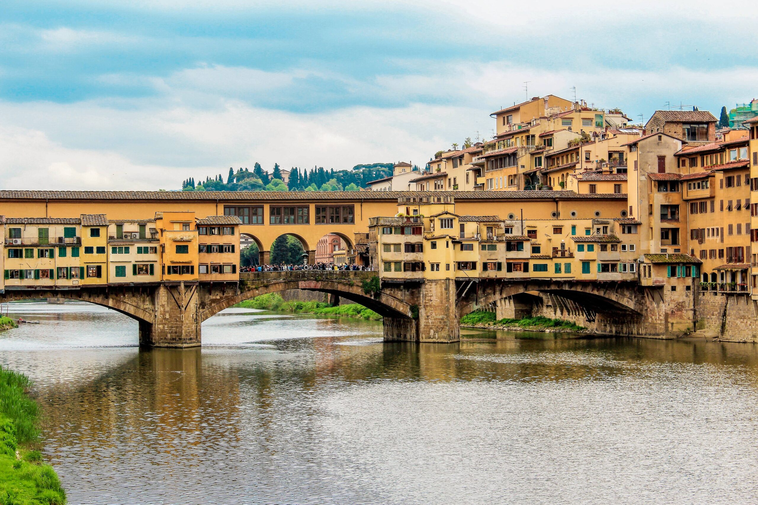 bridge, river with buildings in 24 hours in florence