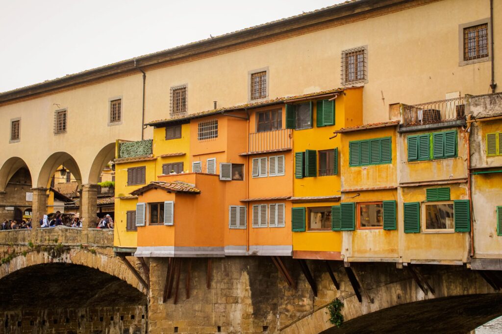 bridge with shops in orange and yellow with stutters while spending 24 hours in Florence italy
