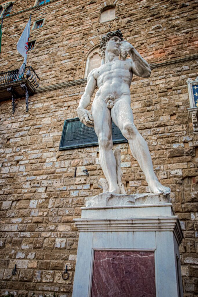 stone statue of man in square as one thing on the Florence-Italy-Itinerary