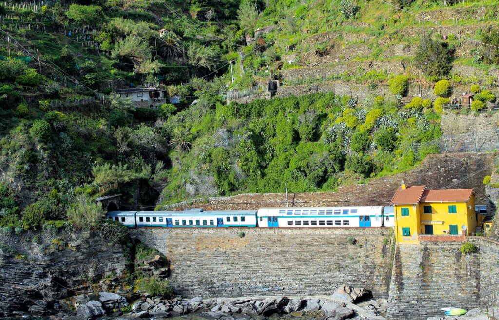 train on rock cliff with mountain on 3 day cinque terre itinerary
