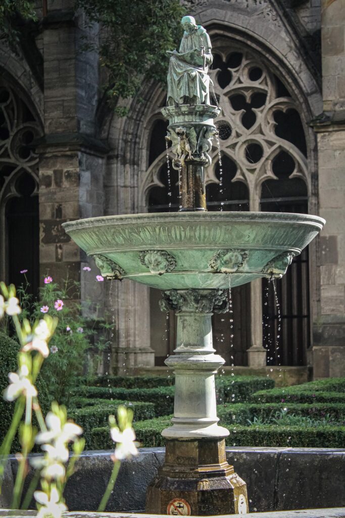 fountain in church garden in day trip to utrecht