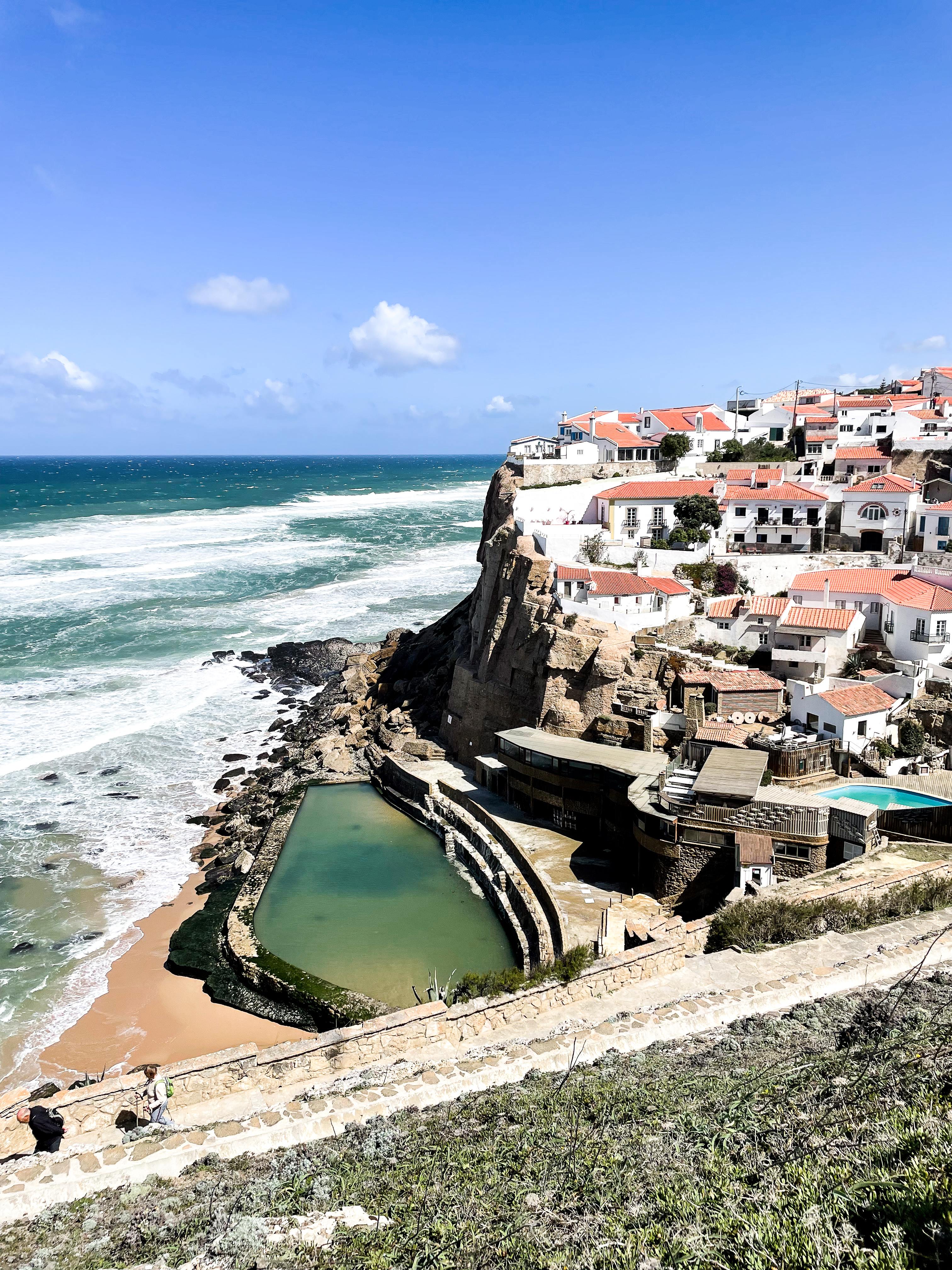 white wash village by ocean on hilltop in portugal