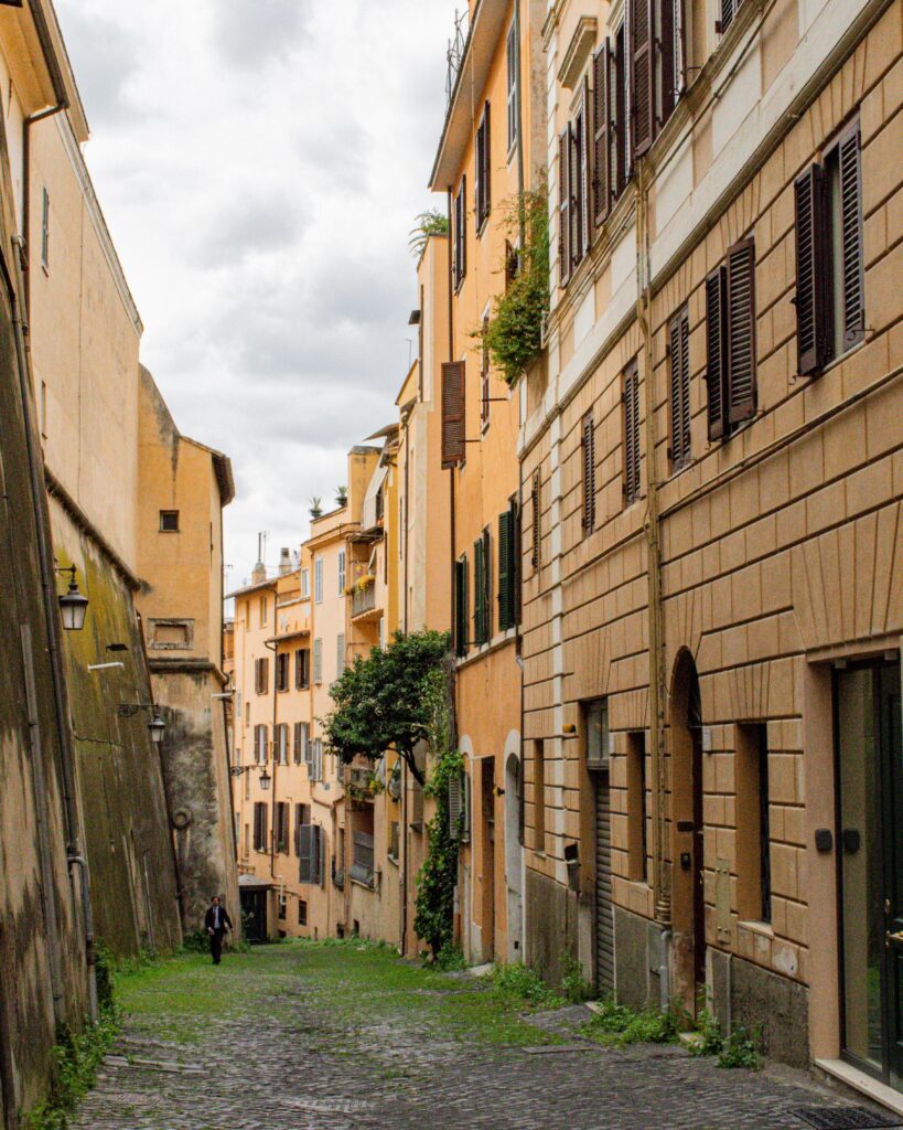 cobbled street with yellow buildings in most beautiful streets in rome
