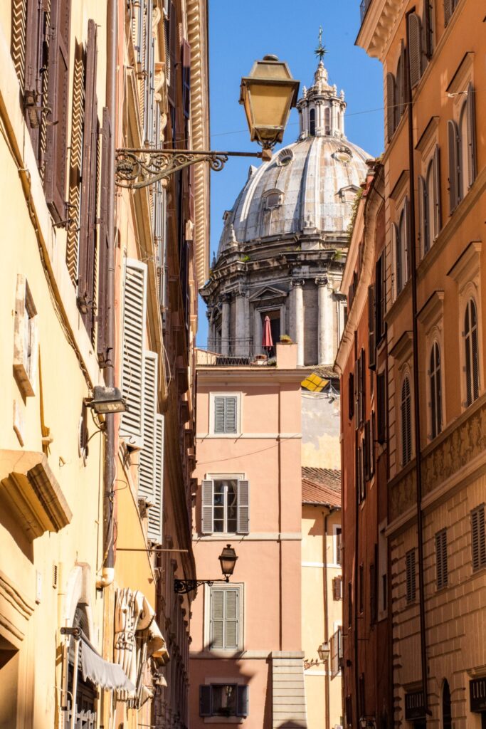 colourful buildings with lantern and dome on famous streets in rome