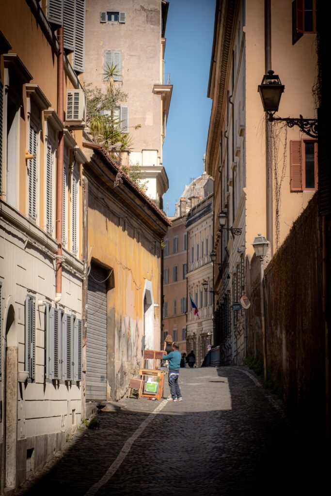street with someone working on furniture in streets of rome