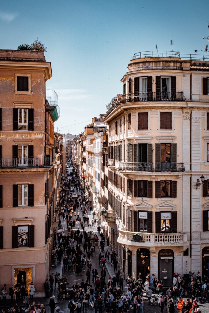 tall buildings with street and people on streets of rome