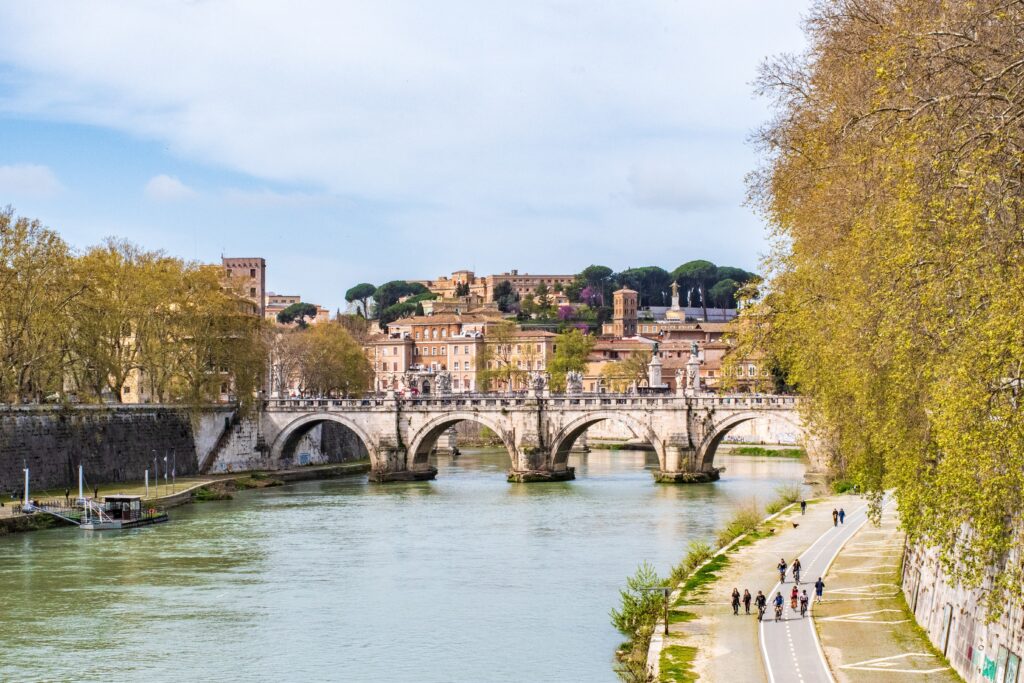 river with walkway and bridge on streets in rome