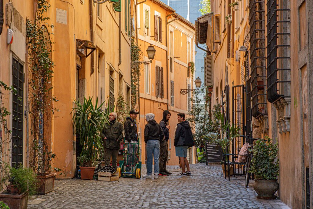 cobbled street with group standing talking in what to see in the jewish ghetto rome