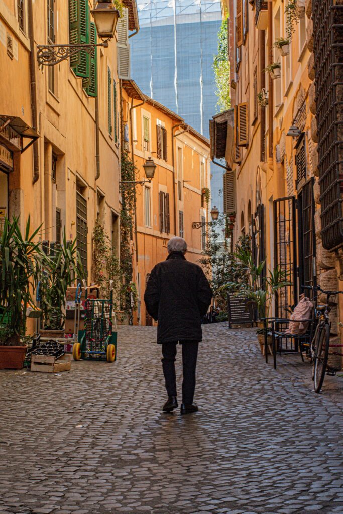 man walking on cobbled rome streets