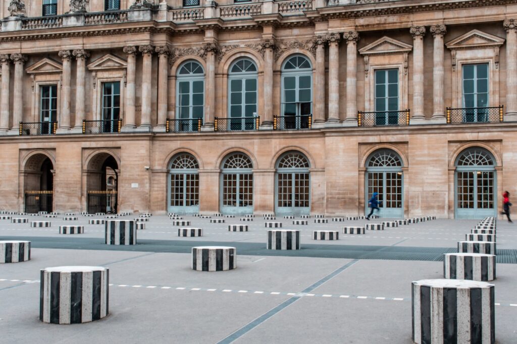 palace with stripped poles on square in why should i visit paris