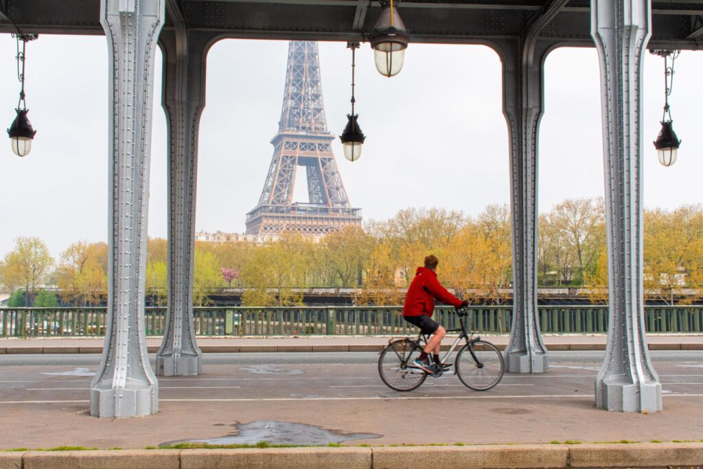 eiffel tower, man on bike in why visit paris