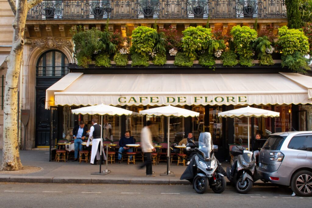 restaurant in paris with awning table and chairs with diners