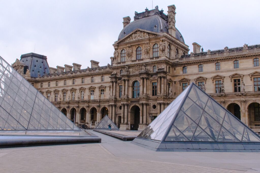 glass triangle with building in paris
