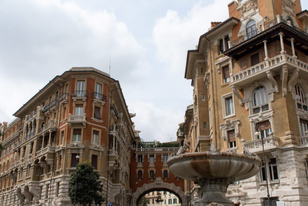 fountain with buildings with arch in non touristy places in rome