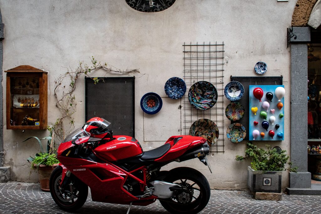 red motorcycle and shop with ceramic plates on wall on a day trip to orvieto from rome