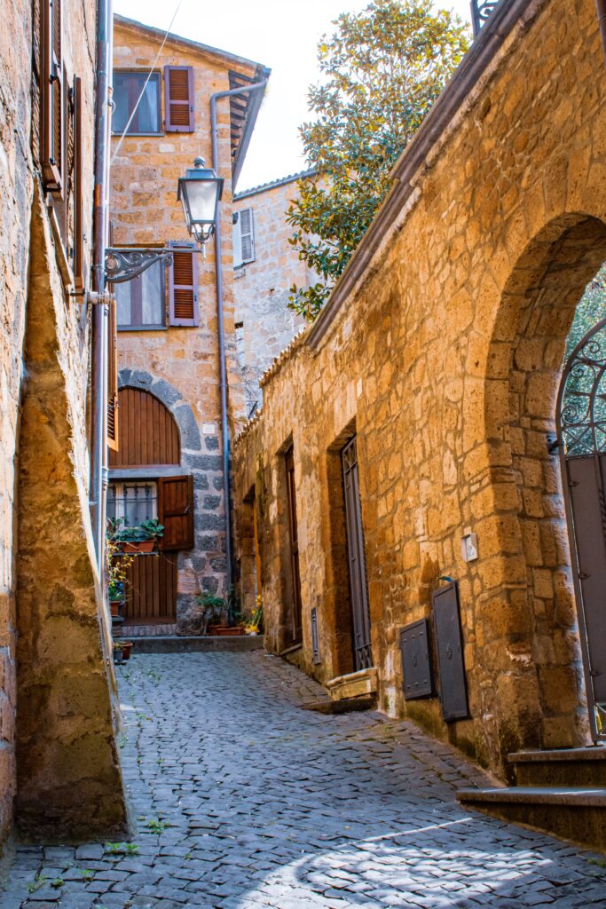 cobble street with tall wall and townhouse on day trip to orvieto from rome
