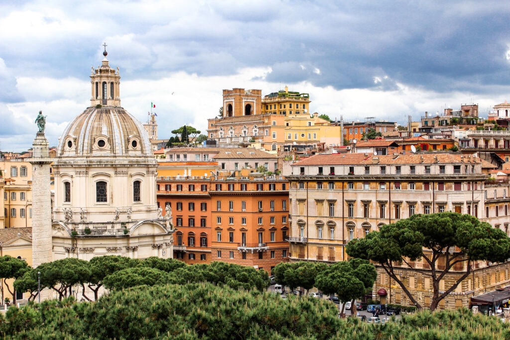 rooftop views of rome with colourful buildings and dome 