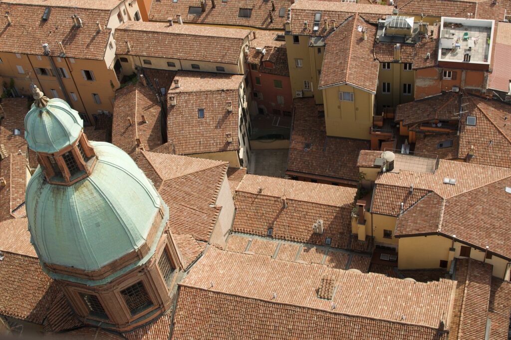 red rooftops and church dome in bologna on italy city breaks