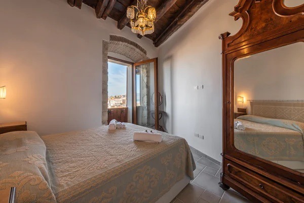 bed with window to city in italy 
